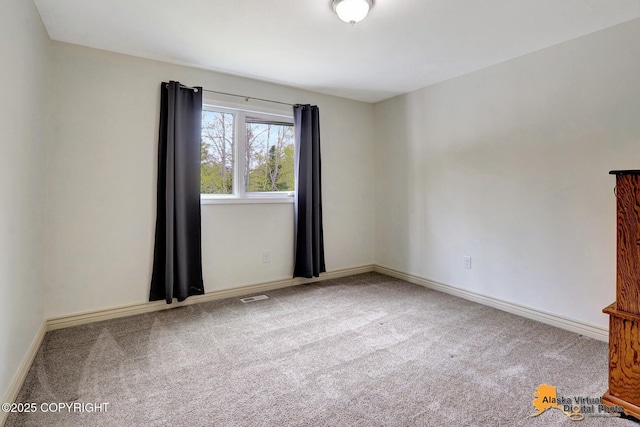 unfurnished room featuring carpet floors and baseboards