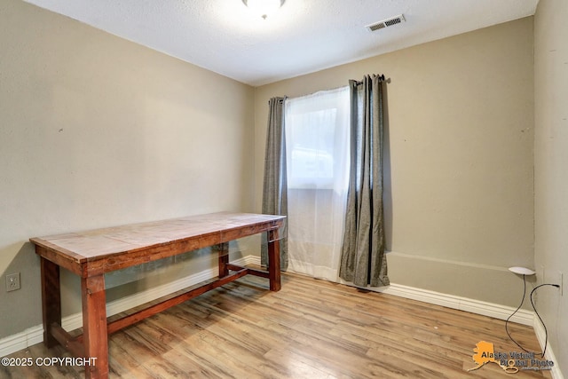 miscellaneous room featuring wood finished floors and baseboards