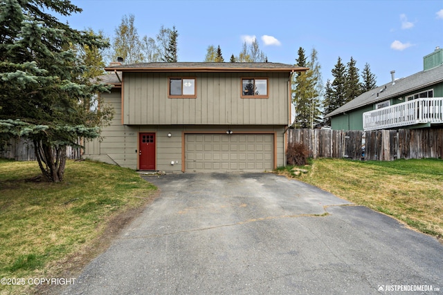 view of front of home featuring asphalt driveway and an attached garage