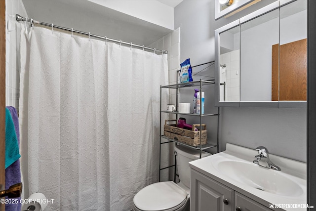full bath featuring toilet, vanity, and curtained shower