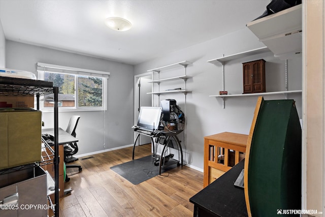 office with wood finished floors and baseboards