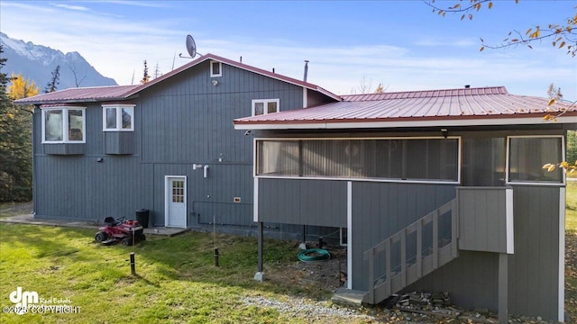 4035 S Tustin Dr, Palmer, AK 99645 - back of house with a sunroom, metal roof, a mountain view, and a lawn