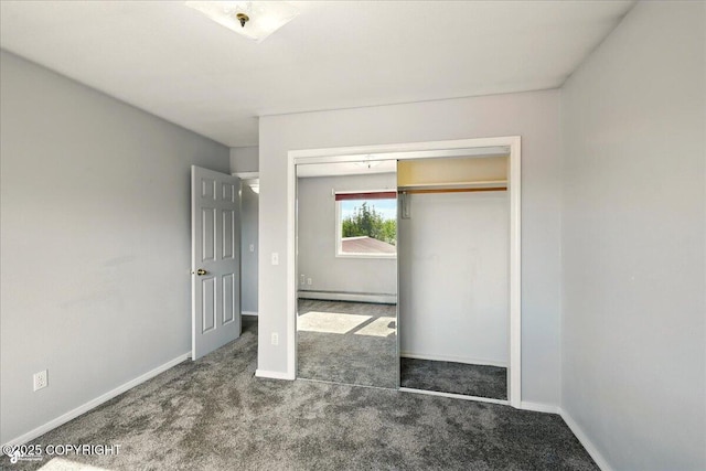 4035 S Tustin Dr, Palmer, AK 99645 - unfurnished bedroom featuring a baseboard heating unit, carpet, a closet, and baseboards