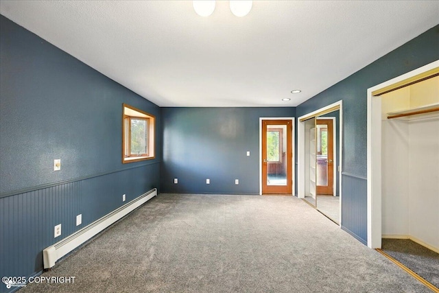 4035 S Tustin Dr, Palmer, AK 99645 - unfurnished bedroom with baseboard heating, carpet flooring, multiple closets, and baseboards