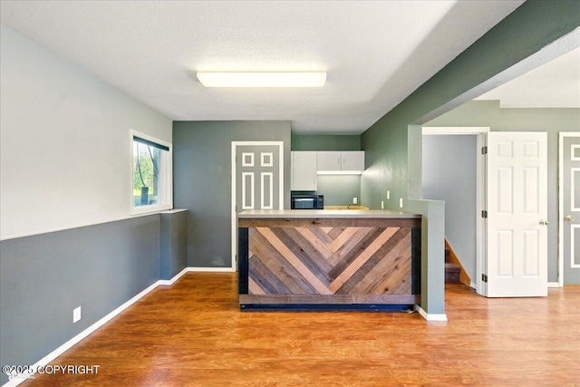 4035 S Tustin Dr, Palmer, AK 99645 - bar area featuring light wood-style floors, black microwave, and baseboards