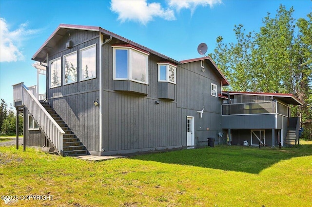 4035 S Tustin Dr, Palmer, AK 99645 - rear view of property with stairway, a sunroom, and a lawn