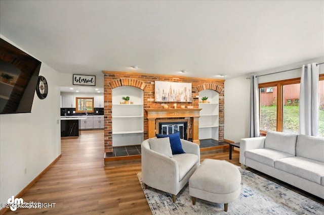 4320 Seeley Cir, Anchorage, AK 99502 - living area with wood finished floors, baseboards, and a fireplace