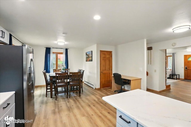 4320 Seeley Cir, Anchorage, AK 99502 - dining room featuring a baseboard radiator, light wood-style floors, and baseboards