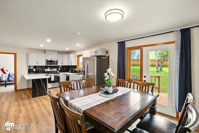 4320 Seeley Cir, Anchorage, AK 99502 - dining space with light wood-style floors, baseboards, and recessed lighting