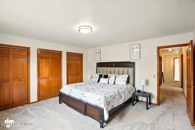 4320 Seeley Cir, Anchorage, AK 99502 - bedroom with light colored carpet, two closets, and baseboards