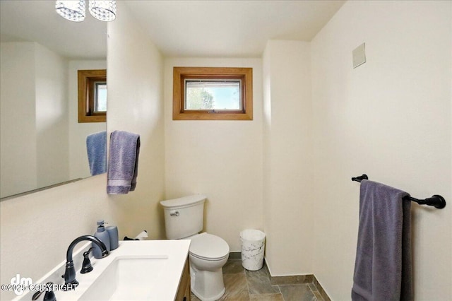 4320 Seeley Cir, Anchorage, AK 99502 - half bathroom featuring toilet, vanity, and baseboards