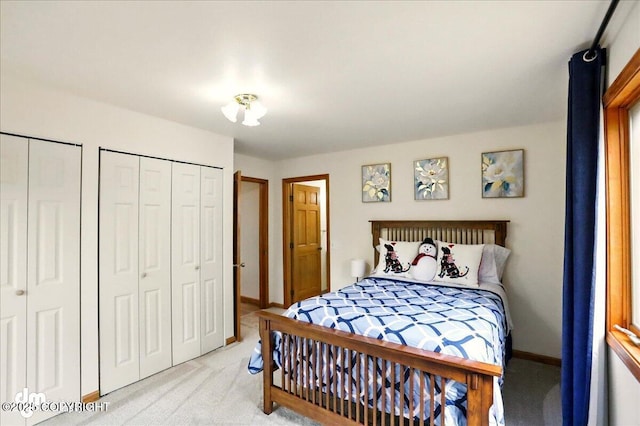 4320 Seeley Cir, Anchorage, AK 99502 - bedroom with light carpet, two closets, and baseboards