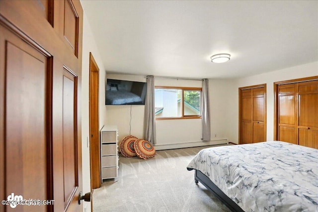 4320 Seeley Cir, Anchorage, AK 99502 - bedroom with light colored carpet, a baseboard heating unit, and multiple closets