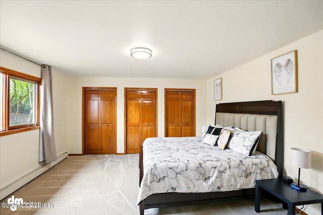 4320 Seeley Cir, Anchorage, AK 99502 - bedroom featuring a baseboard heating unit, light colored carpet, multiple closets, and baseboards
