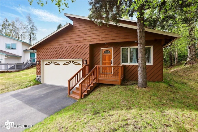 4320 Seeley Cir, Anchorage, AK 99502 - view of front facade featuring asphalt driveway, a garage, and a front lawn