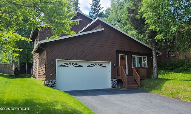 4320 Seeley Cir, Anchorage, AK 99502 - view of front of house with an attached garage, a front yard, and asphalt driveway