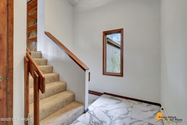 stairs with marble look tile flooring