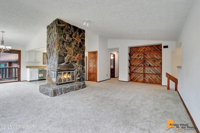 living area featuring lofted ceiling, a textured ceiling, light colored carpet, a chandelier, and a fireplace