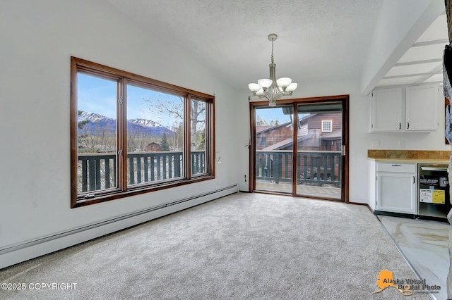 unfurnished dining area featuring a baseboard radiator, a chandelier, vaulted ceiling, light colored carpet, and a mountain view