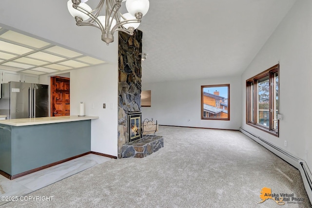 unfurnished living room with light carpet, baseboard heating, a chandelier, a fireplace, and baseboards