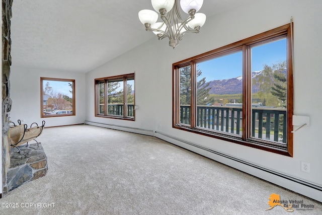 interior space featuring lofted ceiling, carpet, a chandelier, baseboard heating, and a mountain view