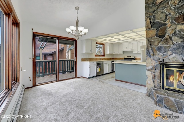 kitchen with stainless steel electric range, a baseboard radiator, a chandelier, a fireplace, and light countertops