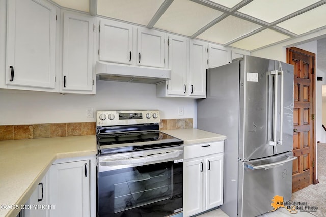 kitchen featuring under cabinet range hood, stainless steel appliances, light countertops, and white cabinetry