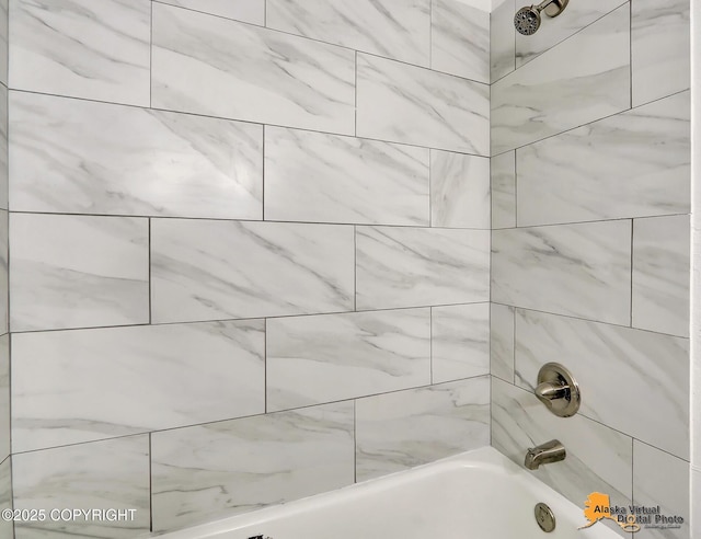 bathroom view of tub / shower combination