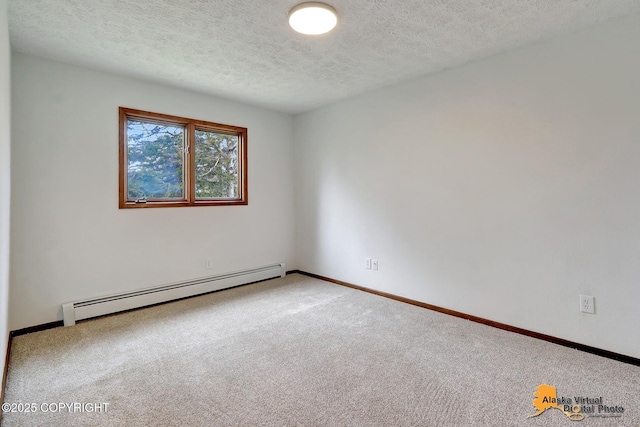 spare room with a baseboard radiator, carpet flooring, a textured ceiling, and baseboards