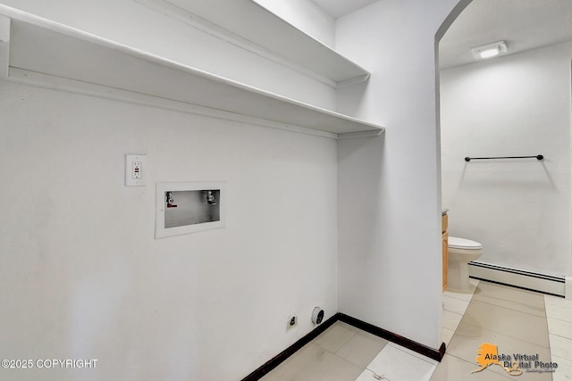 laundry room featuring baseboard heating, washer hookup, arched walkways, and baseboards