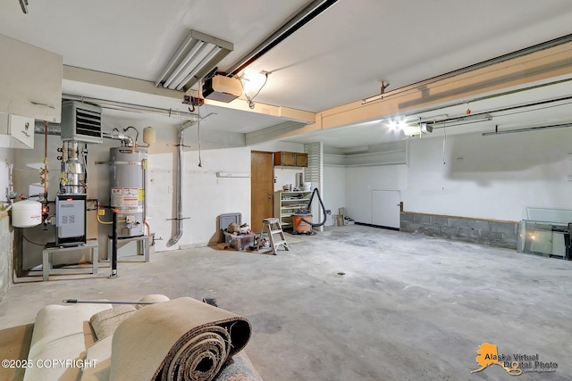 garage with gas water heater and a garage door opener