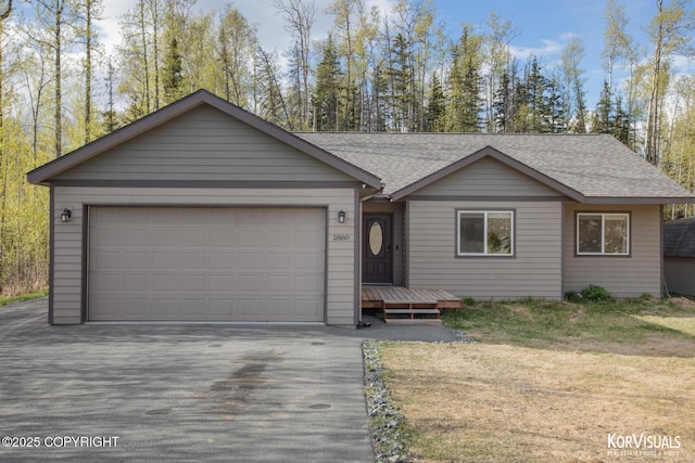 single story home with roof with shingles, driveway, and an attached garage