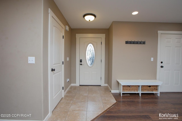 entryway featuring baseboards, light wood finished floors, and recessed lighting