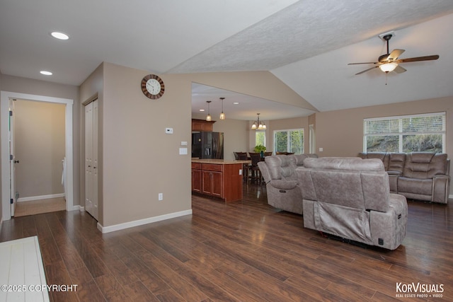living area with dark wood-style flooring, a ceiling fan, baseboards, recessed lighting, and lofted ceiling