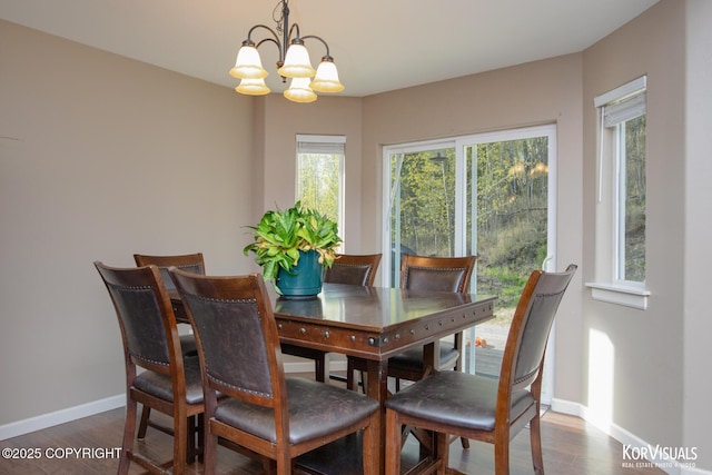 dining room with baseboards, plenty of natural light, a chandelier, and dark wood-type flooring