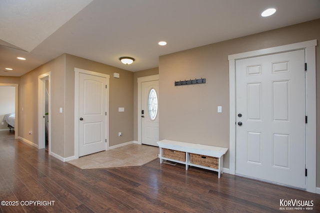 entryway with wood finished floors, baseboards, and recessed lighting