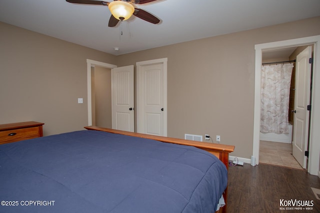 bedroom with wood finished floors, ensuite bathroom, a ceiling fan, and baseboards