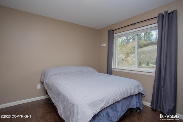 bedroom featuring wood finished floors and baseboards