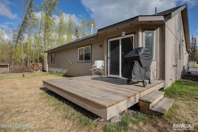 back of property with a deck and a yard