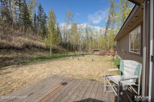 wooden deck featuring a yard