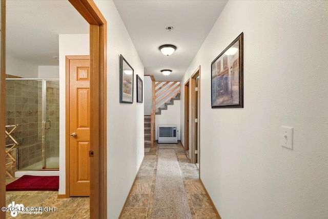 hall featuring stairs, stone finish floors, and baseboards