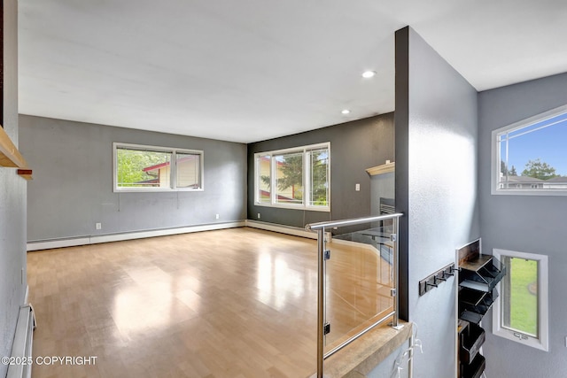 7810 Mae Rene Cir, Anchorage, AK 99502 - living room featuring healthy amount of natural light, a baseboard radiator, wood finished floors, and recessed lighting