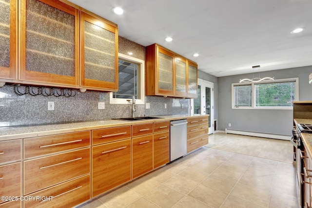 7810 Mae Rene Cir, Anchorage, AK 99502 - kitchen with a baseboard heating unit, appliances with stainless steel finishes, a sink, decorative backsplash, and light countertops