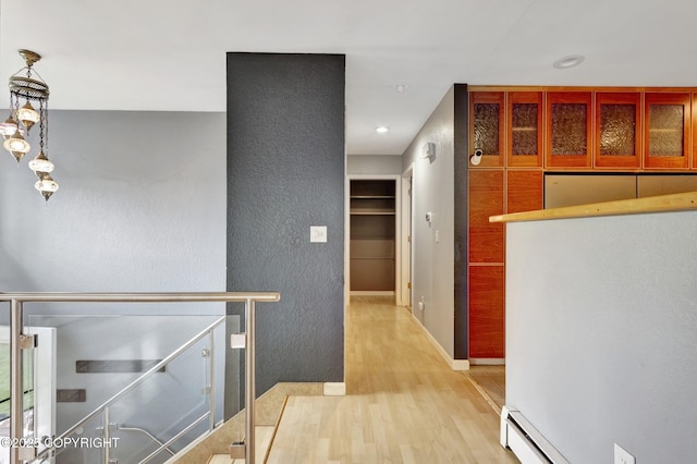7810 Mae Rene Cir, Anchorage, AK 99502 - corridor featuring wood finished floors, a textured wall, and baseboards