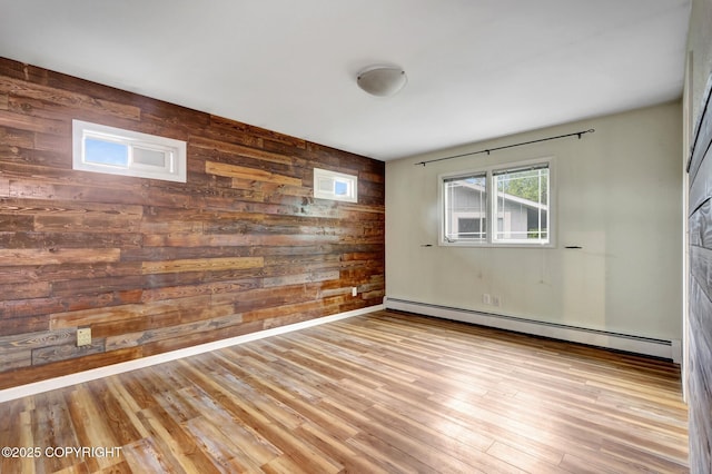 7810 Mae Rene Cir, Anchorage, AK 99502 - unfurnished room featuring wood walls, a baseboard heating unit, and wood finished floors