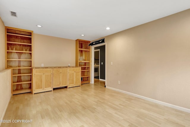 7810 Mae Rene Cir, Anchorage, AK 99502 - empty room featuring light wood-style floors, baseboards, built in features, and recessed lighting