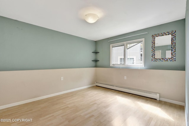 7810 Mae Rene Cir, Anchorage, AK 99502 - spare room featuring a baseboard radiator, wood finished floors, and baseboards