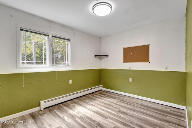7810 Mae Rene Cir, Anchorage, AK 99502 - spare room with baseboard heating, baseboards, and wood finished floors