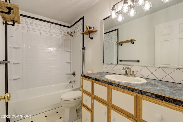 7810 Mae Rene Cir, Anchorage, AK 99502 - bathroom featuring vanity, tub / shower combination, toilet, tile patterned flooring, and decorative backsplash