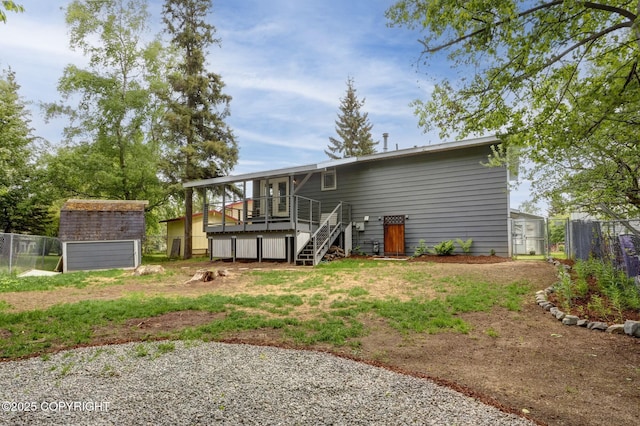 7810 Mae Rene Cir, Anchorage, AK 99502 - rear view of house with stairway and a wooden deck